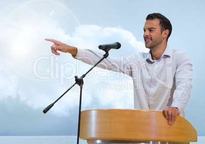 Businessman on podium speaking at conference with clouds