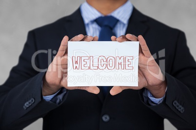 Business man holding a card with welcome text