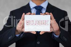 Business man holding a card with welcome text