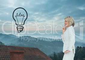 Light bulb icon and Businesswoman standing on Roof with chimney and misty landscape