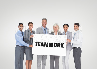 Business people holding a card with teamwork text