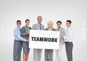 Business people holding a card with teamwork text