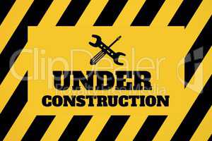 Under construction text with tools graphics against yellow and black background