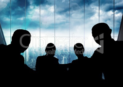 Business people at a meeting silhouettes against building