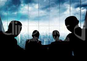 Business people at a meeting silhouettes against building