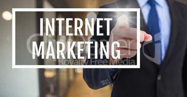 Hand interacting with internet marketing business text against blurred background