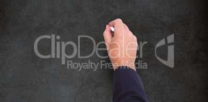 Composite image of hand of a businessman writing with a chalk
