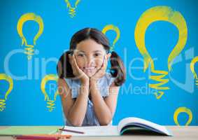 Schoolgirl at desk with light bulb graphics