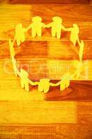 Yellow paper cut out figures formimg circle on table