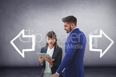 Composite image of business colleagues using digital tablet