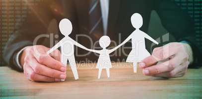 Composite image of mid section of businessman holding paper family