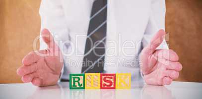 Composite image of mid section of businessman with risk text