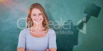 Composite image of smiling teacher standing in front of blackboard
