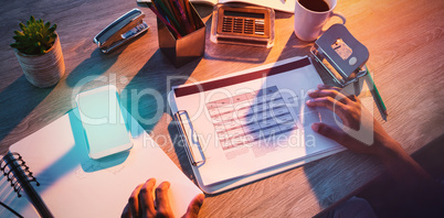 Cropped hands of male executive working at desk