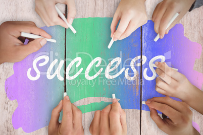 Composite image of business people writing with chalks