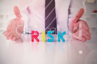 Composite image of mid section of businessman with colorful risk text