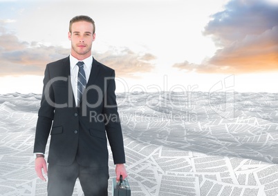 Businessman holding briefcase in sea of documents under sky clouds