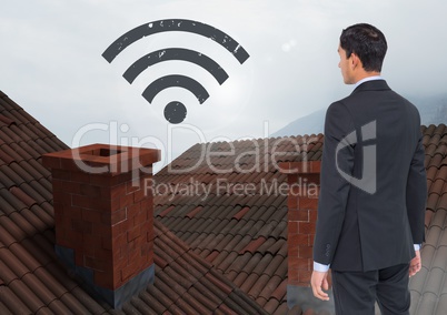 Wi-fi icon and Businessman standing on Roofs with chimney and fog