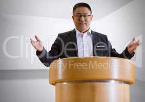Businessman on podium speaking at conference with minimal background