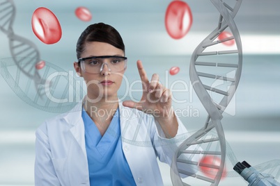 Doctor woman pointing with 3D DNA strands and cells