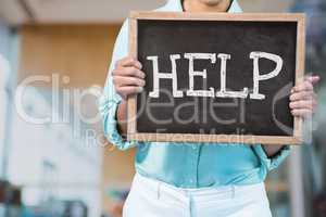Business woman holding a blackboard with help text