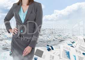 Businesswoman in sea of documents under sky clouds