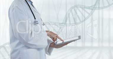 Doctor using a tablet with DNA strand