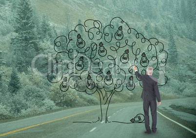 Business man drawing a tree on the road