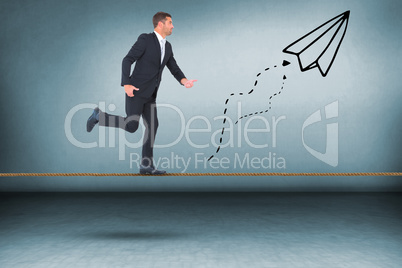 Composite image of businessman walking with his hands out