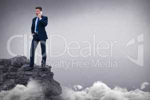 Composite image of portrait of businessman standing talking on smart phone