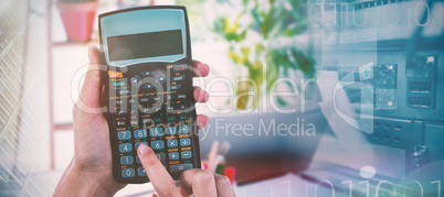 Composite image of hands of businesswoman using calculator