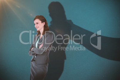 Composite image of smiling businesswoman with arms crossed