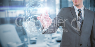 Composite image of businessman using futuristic digital screen