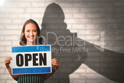 Composite image of portrait of female owner with open sign