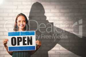 Composite image of portrait of female owner with open sign