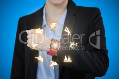 Composite image of businesswoman wearing smart watch
