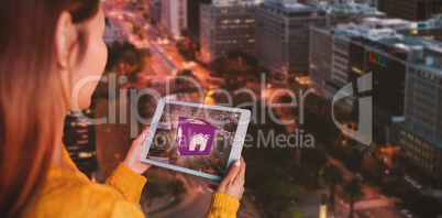 Composite image of smiling asian woman using tablet