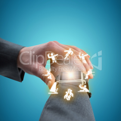 Composite image of businessman checking smart watch