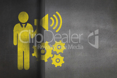 Composite image of businessman holding speaker next to mechanical gear
