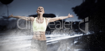 Composite image of fit woman celebrating victory with arms stretched