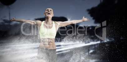 Composite image of fit woman celebrating victory with arms stretched