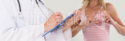 Composite image of doctor writing on clipboard