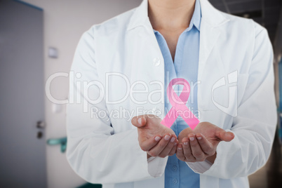 Composite image of midsection of female doctor standing with hands cupped