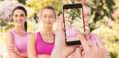 Composite image of hands touching smart phone