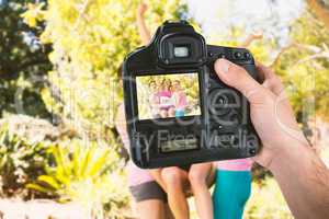 Composite image of cropped hand of photographer holding camera