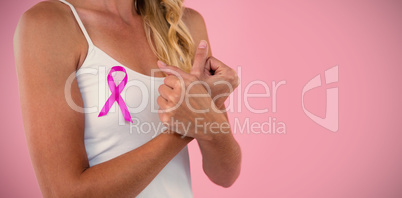 Mid section of young woman with pink ribbon