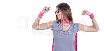 Smiling woman in superhero costume while flexing muscles