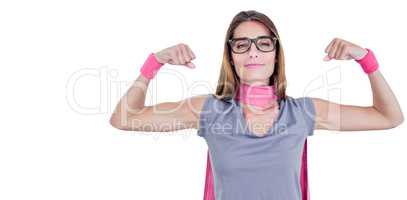 Portrait of smiling woman in superhero costume while flexing muscles
