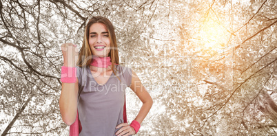 Composite image of portrait of cheerful woman in superhero costume while standing