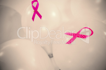 Close-up of pink Breast Cancer Awareness ribbons on balloons